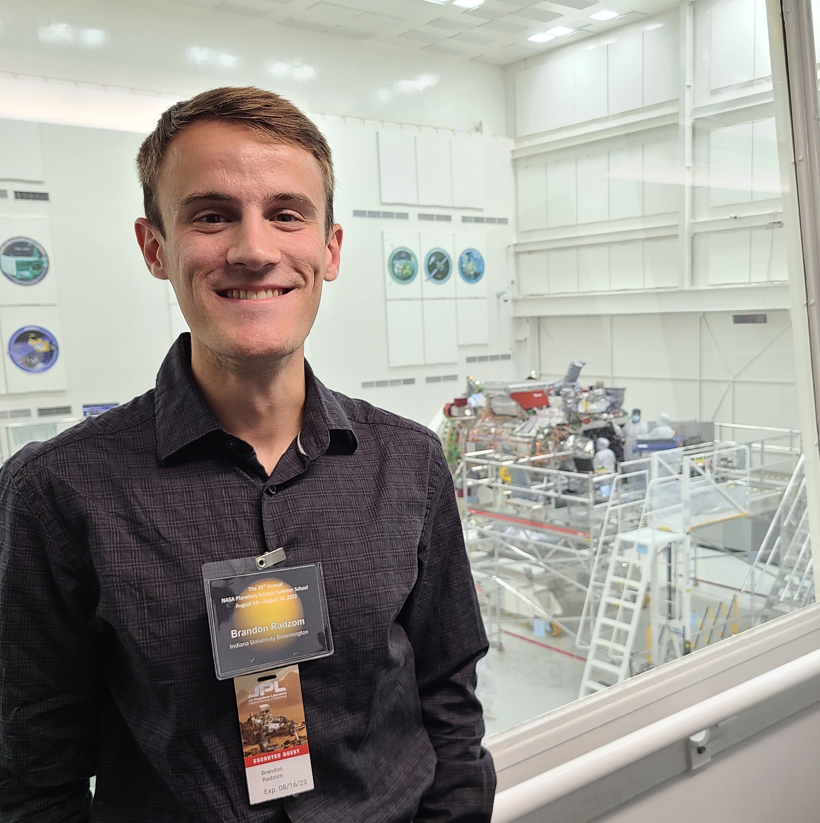 Me in front of the fully-assembled 
									Europa Clipper spacecraft at JPL.