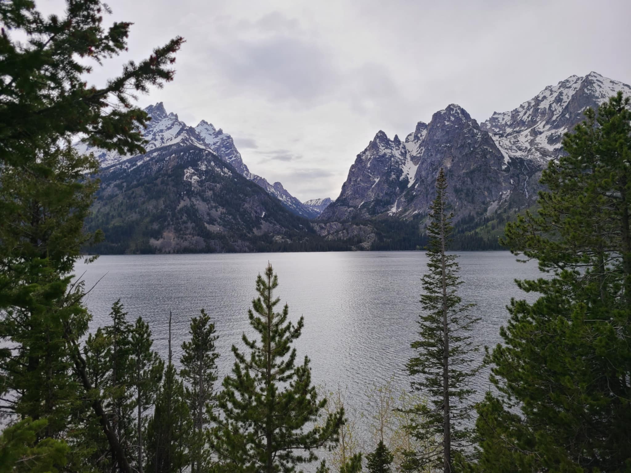 Grand Teton mountain range with a lake in the foreground.